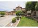 Charming two-story home with a lush green lawn, mature landscaping, and a two car garage at 11563 W Jefferson St, Avondale, AZ 85323