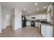 Bright kitchen featuring white cabinetry, dark appliances and ample counter space at 11563 W Jefferson St, Avondale, AZ 85323