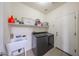 Laundry room with a utility sink, shelving and front loading washer and dryer at 11563 W Jefferson St, Avondale, AZ 85323