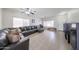 Spacious living room with tiled floors, a ceiling fan and a large sofa for comfortable lounging at 11563 W Jefferson St, Avondale, AZ 85323