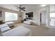 Bright living room with comfortable seating, large window, and mounted TV at 11563 W Jefferson St, Avondale, AZ 85323