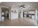 Open concept living room with tile flooring leading into the kitchen, bathed in natural light at 11563 W Jefferson St, Avondale, AZ 85323