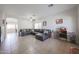Bright living room featuring tile floors, a ceiling fan, and a comfortable seating area at 11563 W Jefferson St, Avondale, AZ 85323