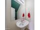 Charming powder room with a pedestal sink and decorative mirror at 11563 W Jefferson St, Avondale, AZ 85323