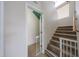 Staircase leading to the powder room, with a carpeted staircase and baby gate at 11563 W Jefferson St, Avondale, AZ 85323