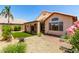 Well-maintained backyard with desert landscaping, artificial turf, and a covered patio at 11622 W Buck Mountain Ct, Surprise, AZ 85378