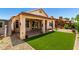 Spacious backyard featuring a covered patio and a meticulously maintained artificial lawn at 11622 W Buck Mountain Ct, Surprise, AZ 85378