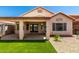Backyard showing covered patio area and artificial turf, perfect for relaxing and entertaining at 11622 W Buck Mountain Ct, Surprise, AZ 85378