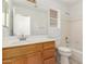 Bright bathroom features a large mirror, a window for natural light, and a combined shower and tub at 11622 W Buck Mountain Ct, Surprise, AZ 85378
