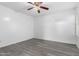 Clean bedroom with modern ceiling fan and vinyl plank flooring at 11622 W Buck Mountain Ct, Surprise, AZ 85378