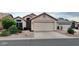 Charming single-story home with a well-manicured desert front yard and attached garage at 11622 W Buck Mountain Ct, Surprise, AZ 85378