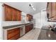 Spacious kitchen with stainless steel appliances, wood cabinets, granite counters, and a tile floor at 11622 W Buck Mountain Ct, Surprise, AZ 85378