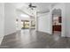Bright living room with neutral paint, vinyl plank flooring and modern ceiling fan at 11622 W Buck Mountain Ct, Surprise, AZ 85378