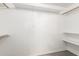 Spacious walk-in closet with built-in shelving and hanging rods at 11622 W Buck Mountain Ct, Surprise, AZ 85378