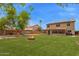 The backyard offers a playset, fire pit, and well-maintained lawn, great for outdoor enjoyment at 12325 W Canterbury Dr, El Mirage, AZ 85335