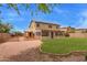 The backyard features a lush lawn adjacent to a gravel area with a shed, creating a versatile outdoor space at 12325 W Canterbury Dr, El Mirage, AZ 85335