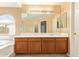 Bathroom showcasing the vanity with lots of counter space and mirrors, with the tub and shower area to the side at 12325 W Canterbury Dr, El Mirage, AZ 85335