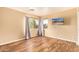Bedroom featuring hardwood floors, a window, and gray curtains at 12325 W Canterbury Dr, El Mirage, AZ 85335