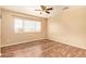 Bedroom with vinyl flooring and a large window with horizontal blinds at 12325 W Canterbury Dr, El Mirage, AZ 85335