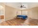 Bedroom featuring laminate floors, ceiling fan, neutral walls and an archway leading to the bathroom at 12325 W Canterbury Dr, El Mirage, AZ 85335