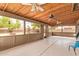 A covered patio provides a view of the backyard, complete with a playset and fire pit at 12325 W Canterbury Dr, El Mirage, AZ 85335