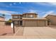 Attractive two-story home boasts a tile roof, spacious three-car garage and low maintenance desert landscaping at 12325 W Canterbury Dr, El Mirage, AZ 85335