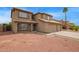 Charming two-story home boasts tile roof, three-car garage, and low-maintenance desert landscaping at 12325 W Canterbury Dr, El Mirage, AZ 85335
