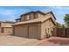 Side view of home featuring a three car garage and low maintenance desert landscaping at 12325 W Canterbury Dr, El Mirage, AZ 85335