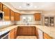Kitchen showcasing granite countertops, stainless steel appliances, and cabinetry with views out the window at 12325 W Canterbury Dr, El Mirage, AZ 85335