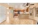 Kitchen with granite countertops, stainless steel appliances, tiled floors, and views into the living area at 12325 W Canterbury Dr, El Mirage, AZ 85335