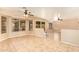 Spacious living room with tile flooring, neutral paint and multiple ceiling fans at 12325 W Canterbury Dr, El Mirage, AZ 85335