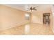 Spacious living room boasts tile floors, neutral walls, and a ceiling fan for added comfort at 12325 W Canterbury Dr, El Mirage, AZ 85335