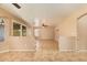 Large living room with tile floors, neutral paint and sliding glass door at 12325 W Canterbury Dr, El Mirage, AZ 85335