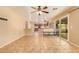 Spacious living room area featuring tile floors, neutral walls, and an open layout concept into the kitchen at 12325 W Canterbury Dr, El Mirage, AZ 85335
