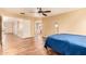 Main bedroom featuring laminate floors, a ceiling fan, neutral walls and an en-suite bathroom at 12325 W Canterbury Dr, El Mirage, AZ 85335