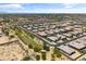 A high altitude view of a desert neighborhood with evenly spaced homes and landscaping at 12516 W Mclellan Ct, Glendale, AZ 85307