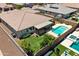 Aerial view showcases the backyard oasis featuring a pool, covered patio, and meticulously landscaped lawn at 12516 W Mclellan Ct, Glendale, AZ 85307