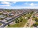A high-angle aerial view captures the community with parks, homes with private pools, and mature landscaping at 12516 W Mclellan Ct, Glendale, AZ 85307