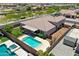 Beautiful aerial view of a backyard with a pool, patio, outdoor kitchen, and green grass at 12516 W Mclellan Ct, Glendale, AZ 85307
