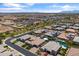 An aerial view of a desert neighborhood with evenly spaced homes and landscaping at 12516 W Mclellan Ct, Glendale, AZ 85307