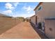 The empty backyard features a gated fence and space for potential landscaping at 12516 W Mclellan Ct, Glendale, AZ 85307