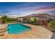 This backyard features a refreshing pool, covered patio, and a well-maintained lawn, perfect for outdoor entertaining at 12516 W Mclellan Ct, Glendale, AZ 85307