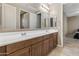 Bathroom features double sinks with a large mirror and wooden cabinets at 12516 W Mclellan Ct, Glendale, AZ 85307