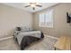 Bedroom featuring carpet, window with plantation shutters, and a ceiling fan at 12516 W Mclellan Ct, Glendale, AZ 85307