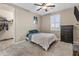 Bedroom featuring carpet, fan, window with plantation shutters, and walk-in closet at 12516 W Mclellan Ct, Glendale, AZ 85307
