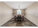 Simple dining room area with a wood table, leather chairs, and wood-look flooring at 12516 W Mclellan Ct, Glendale, AZ 85307