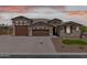 Charming single-Gathering home featuring a three-car garage and desert landscaping at 12516 W Mclellan Ct, Glendale, AZ 85307