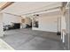The large garage features concrete flooring, tall ceilings, and ample space for parking and storage at 12516 W Mclellan Ct, Glendale, AZ 85307