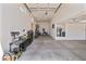 The large garage features concrete flooring, tall ceilings, and ample space for parking and storage at 12516 W Mclellan Ct, Glendale, AZ 85307