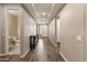 Hallway features tile flooring, neutral walls, recessed lighting, and a bathroom with a pedestal sink and toilet at 12516 W Mclellan Ct, Glendale, AZ 85307